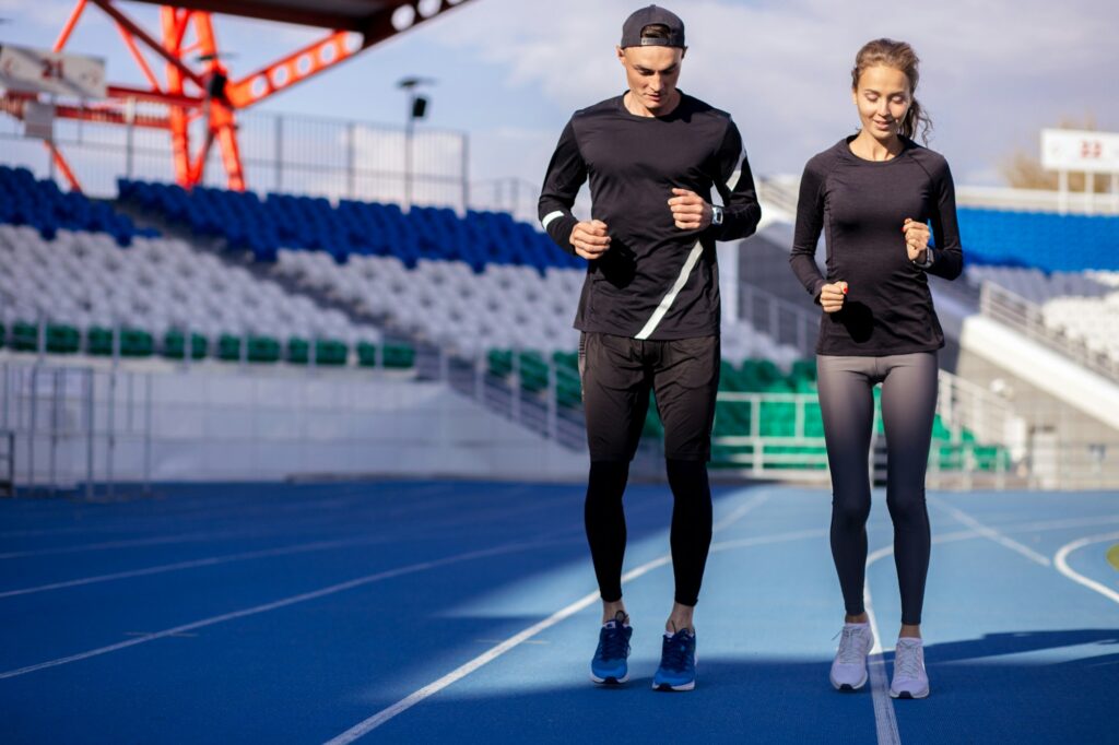 girl working out with personal trainer in the arena